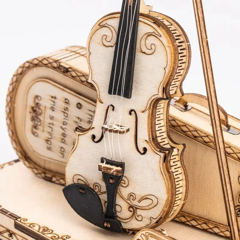 Decorated wooden violin model from VoxPuzzle Violin 3D Puzzle with detailed instructions.