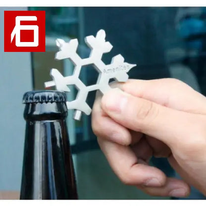 A Person Holding a Bottle Opener With a Snowfl