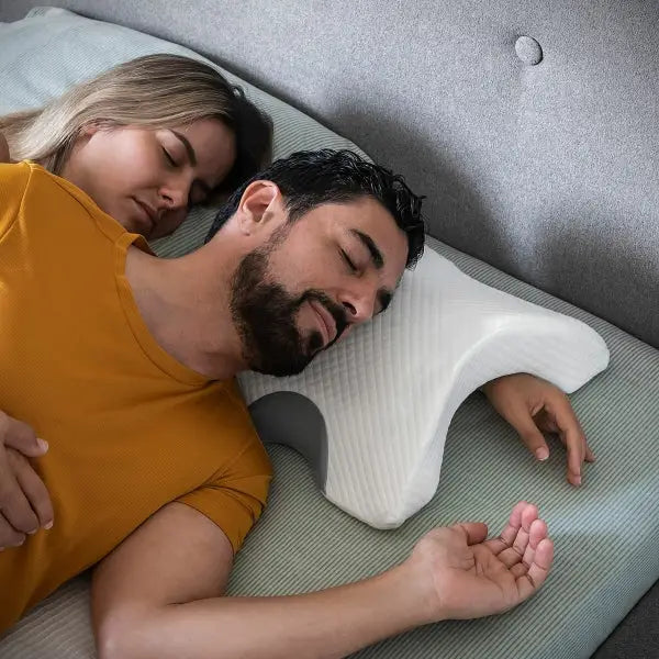 Couple sleeping happily on a Cozzy Viscoelastic Cervical Pillow.