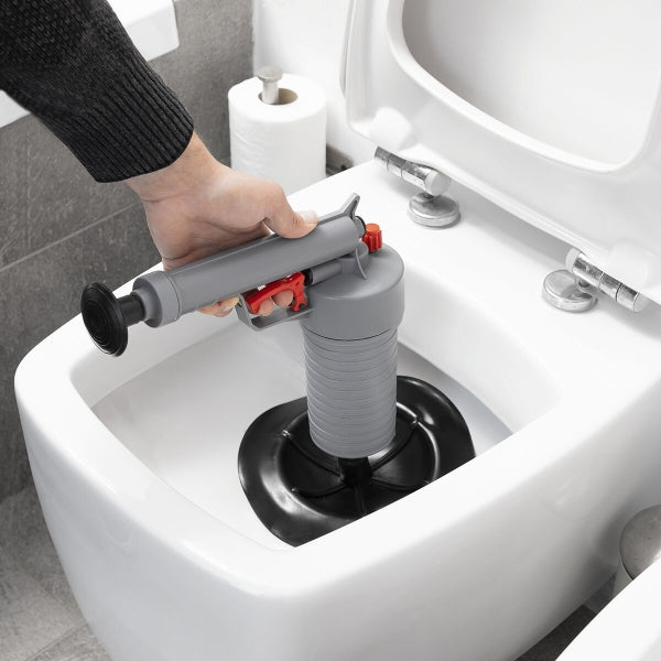 KlinGun Drain Cleaner in use to unclog a toilet with compressed air.