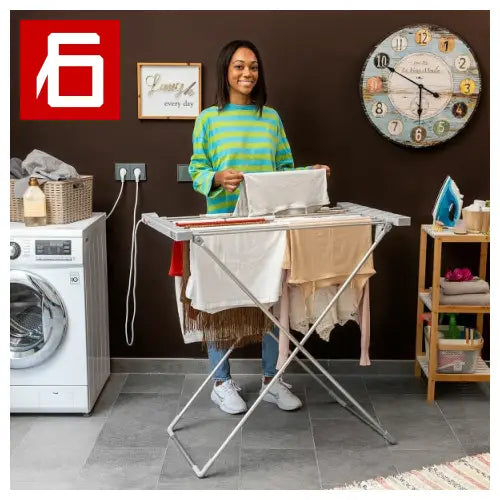 Mujer planchando detrás de una tabla con tendedero eléctrico plegable Dryak.