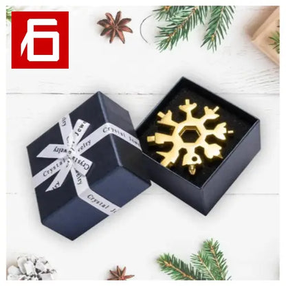 A Black Box With a Gold Snowflake And a White Ribbon