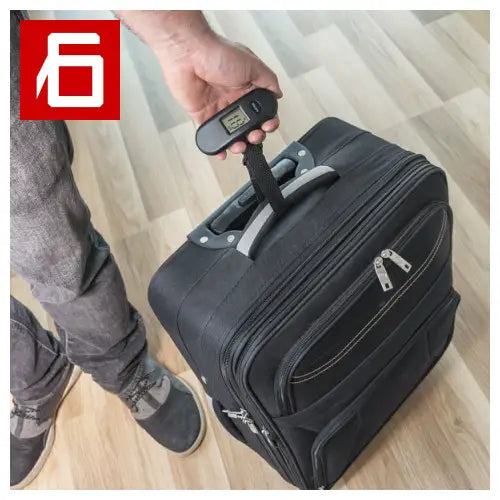 Black suitcase with digital scale, LCD screen and automatic shutdown.